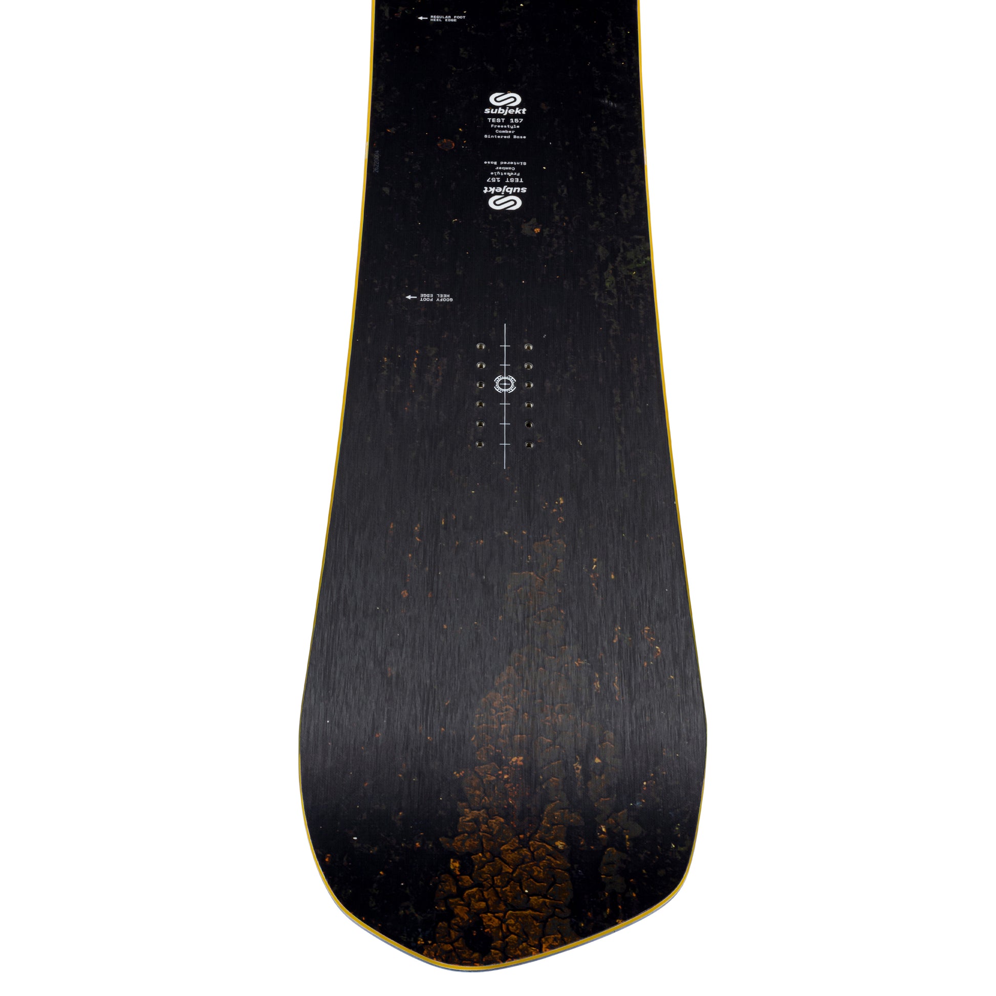 A top-down view of a snowboard deck, showing a dark black wood grain finish with a subtle gold outline along the edges and white printed graphics and branding.